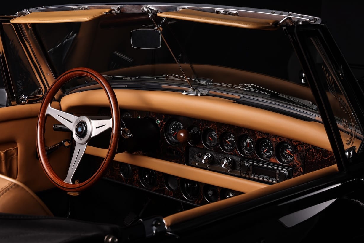 Clenet convertible interior with wood steering wheel and tan leather